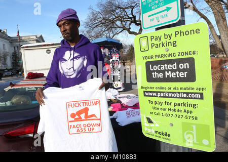 January 20, 2018 - Washington Dc, DC, U.S - A vendor wearing a Prince hoodie has a smoke while selling commemorative t-shirts during the 2018 Women's March on Washington DC. (Credit Image: © Krista Kennell via ZUMA Wire) Stock Photo