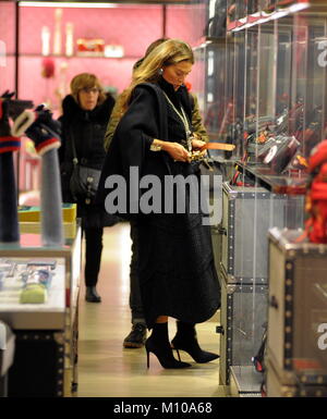 Milan, Fiona Swarovki in the center for shopping but does not want to be photographed Fiona Swarovski arrives downtown with her personal assistant on a rainy afternoon to do some shopping. Here she enters the 'GUCCI' boutique in via Montenapoleone while she tries some bags and belts, then enters 'COVA' for a coffee break, then a walk up to 'BULGARI' the prestigious jewelery. Perhaps because of this, in order not to show that she can buy other competing brands, Fiona Swarovski decides to always walk with an umbrella in front of her face so as not to be photographed. It leaves the jewelry store  Stock Photo