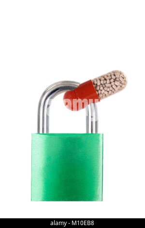 drug capsule trapped in a blue metal padlock on white Stock Photo