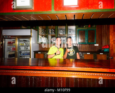 Two smiling young Bornean barmen at Tabin Wildlife Resort, Sabah, Borneo, Malaysia Stock Photo