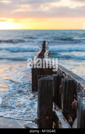 A Victor Harbor beach sunrise over the erosion groynes in South ...