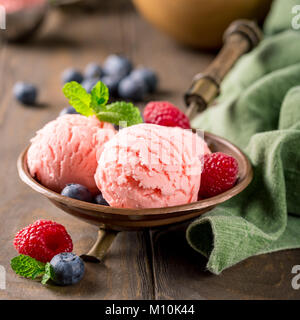 Raspberry ice cream in copper bowl. Stock Photo
