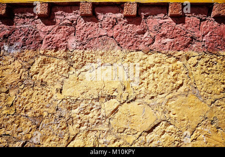 Old cracked clay stone wall background or texture. Stock Photo