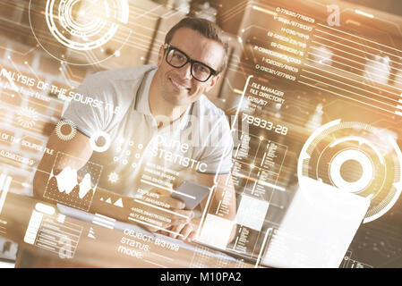 Handsome smiling man using his smart phone Stock Photo