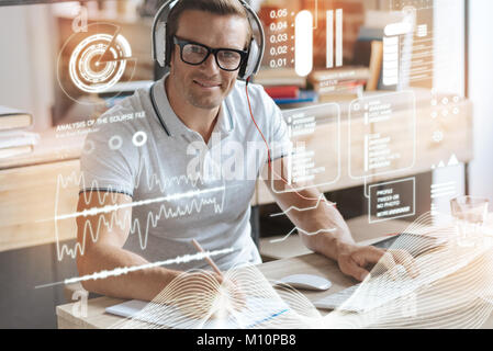Handsome smiling man working on the project Stock Photo