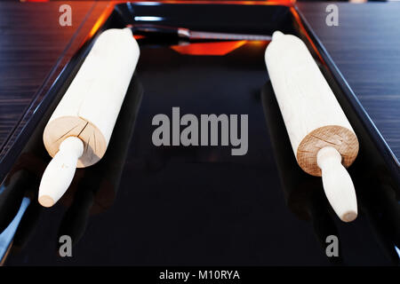 Kitchen rolling pins on black background Stock Photo