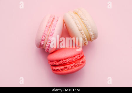 Top view of mini pink and white macaron on soft sweet pink paper background Stock Photo