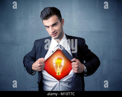 Businessman ripping off shirt and idea light bulb appears on his chest concept on backround Stock Photo