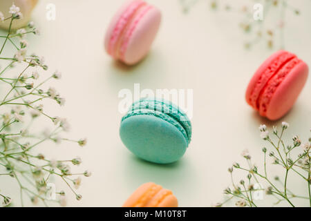 Morning cup of coffee, cake macaron, gift or present box and flower on light table from above. Beautiful breakfast. Flat lay style. Stock Photo