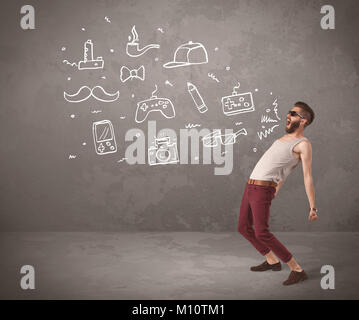 A funny hipster person in casual urban clothing shouting drawn everyday items like camera, tie or pen on city wall concept Stock Photo