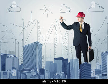 A young architect planning and drawing a happy city sight with blue skyscrapers, sun, clouds Stock Photo