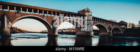 beautiful river landscape - covered bridge over Ticino river at Pavia - italian landscape panorama Stock Photo