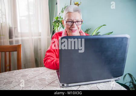 Senior old woman using her laptop at her home Stock Photo