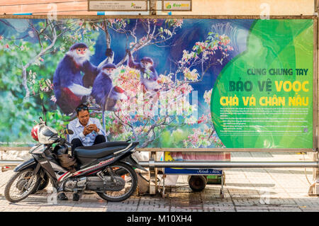 Motorcyclist taking break at bush shelter in city of Da Nang Vietnam