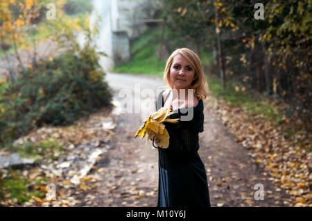 Beautiful blond woman in autumn park Stock Photo