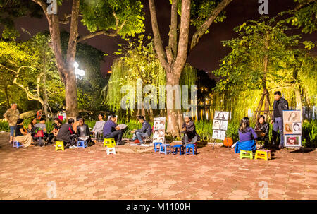 Artist and illustrators working beside Hoan Kiem lake Hanoi Vietnam Stock Photo