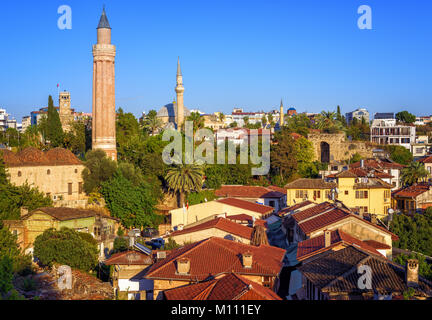 Red tile roofs of the Antalya Old Town, Turkey, with Yivli Minaret, Clock Tower and Tekeli Mehmet Pasa mosque Stock Photo