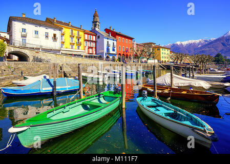 Colorful boats in old town of Ascona on Lago Maggiore lake in the Alps mountain, Ticino, Switzerland Stock Photo