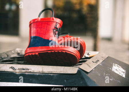 A pair of child's Wellington boots abandoned on a bin in Glasgow city centre, Scotland Stock Photo