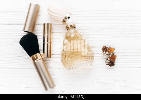 luxury jewelry perfume make up essentials flat lay on white rustic wooden table in soft morning light. space for text. fashion blogger. modern woman s Stock Photo