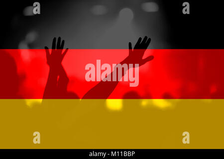 Crowd of football, soccer fans with raised arms with blending Germany flag Stock Photo