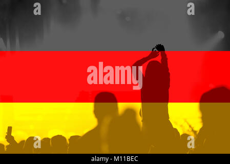 Crowd of football, soccer fans with raised arms with blending Germany flag Stock Photo