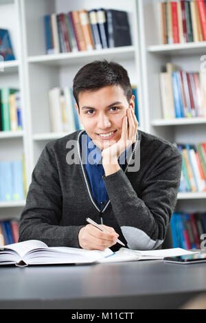 Happy student learning in library Stock Photo