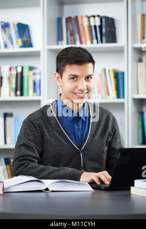 Happy student learning in library Stock Photo
