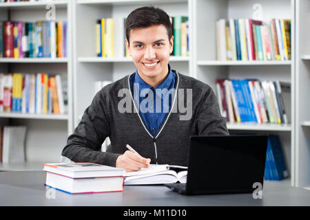 Happy student learning in library Stock Photo