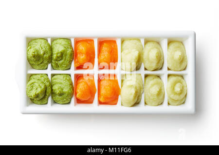 Pureed baby food in ice cube trays ready for freezing isolated on white background, top view Stock Photo