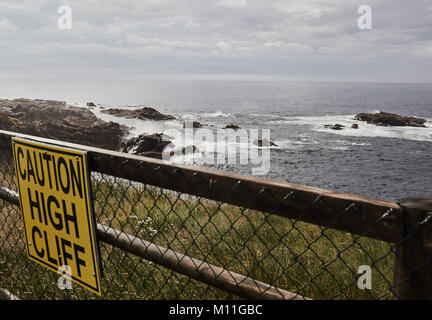 Caution high cliff warning sign, Cape Breton Island, Nova Scotia, Canada Stock Photo