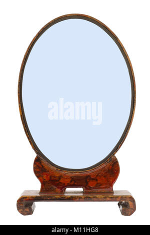 Oval handmade old wooden vinage frame for my grandmother's mirror. Frame isolated on white.  Glass isolated on blue Stock Photo