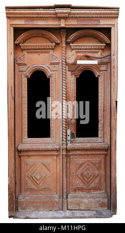 A very old archaic wooden door and frame is painted red. The paint crackled and the tree started to rot. Isolated on white. Glass isolated on black. Stock Photo