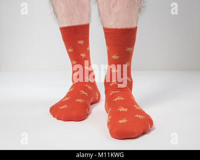 Men's feet in funny, colorful socks on a white background Stock Photo