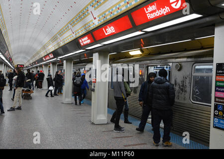 Passengers board a south bound Red Line train on the State Street Subway. The Lake St. stop provides easy access to Chicago's Theater District. Stock Photo