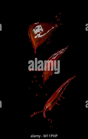 Hot chocolate splash collection isolated on a black background. Liquid high-speed photography. Food in motion. Stock Photo