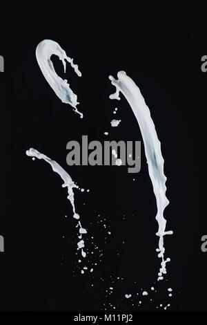 Milk splash collection. White splashes isolated on a black background. Liquid high-speed photography. Food in motion. Stock Photo