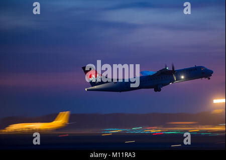 Air Serbia ATR-72 turboprop regional commuter aircraft taking off in dusk Stock Photo