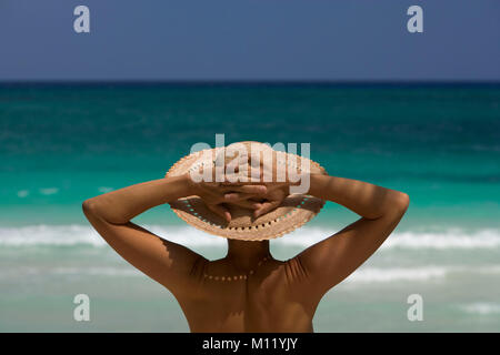 Mexico. Yucatan peninsula. Tulum. Female tourist with sun hat looking at sea. Stock Photo