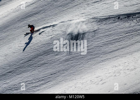 A skier skis off piste in the French alpine ski resort of Courchevel. Stock Photo