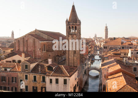 Rooftop view over Rio de San Barnaba canal, San Barnaba church and campanile and Dorsoduro, Venice, Veneto, Italy in winter  sunshine with light mist Stock Photo