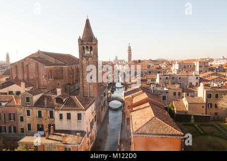 Rooftop view over Rio de San Barnaba canal, San Barnaba church and campanile and Dorsoduro, Venice, Veneto, Italy in winter  sunshine with light mist Stock Photo