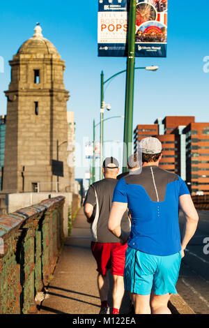 Joggers cross Longfellow Bridge between Boston and Cambridge in 2013. The bridge has been undergoing restoration and will reopen in June 2018. Stock Photo