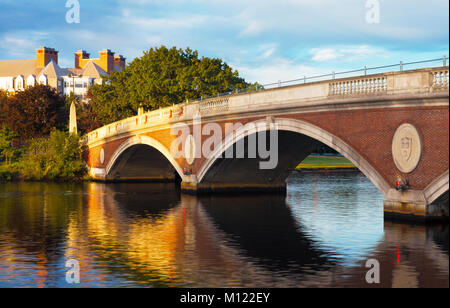 Harvard footbridge across the Charles River links Cambridge and Boston with reflections on the water below. Beautiful early morning light. Stock Photo