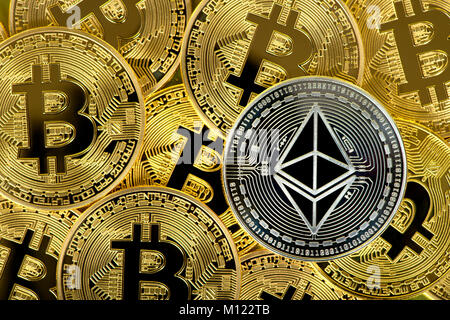 Cryptocurrency,digital currency,silver coin Ethereum on gold Bitcoin coins Stock Photo