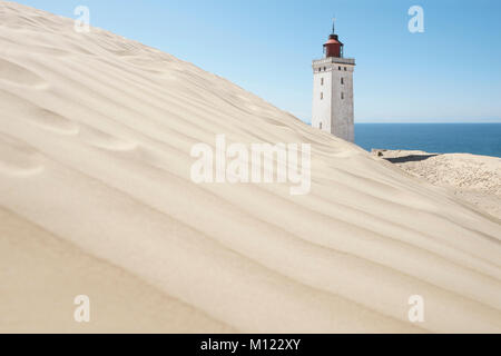 Lighthouse behind sand dune,Rubjerg Knude,Denmark Stock Photo