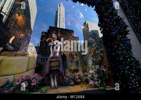 Christmas Window display of Saks Fifth Avenue department store with the reflection of Rockefeller Center in the background.Manhattan.New York City.USA Stock Photo