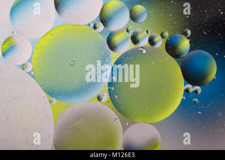 Abstract image with colorful circles and shapeless bodies on a colored background.