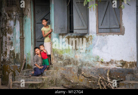 children at a door of their home in rural Bangladesh Stock Photo