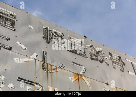 Painted metal sign, Japanese, on an old building; Tokyo, Japan Stock Photo